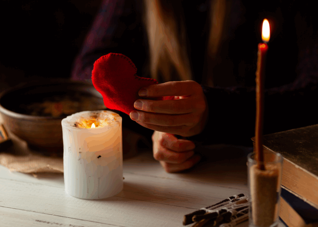Woman holding a hearth mannequin burning it into a candle more like psychic performance